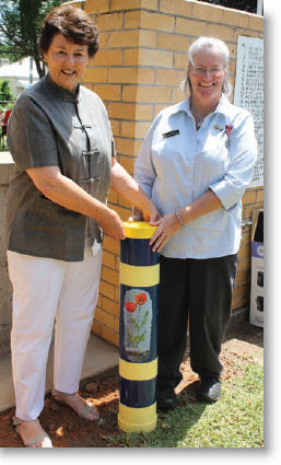 Cr Catherine Egan and New England Mutual’s Robyn Ritchie bury the Time Capsule. 