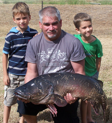 Chris Baldock with grandsons and winning fish.