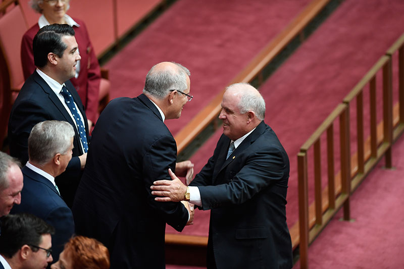 Senator John Williams being congratulated by Prime Minister Scott Morrison