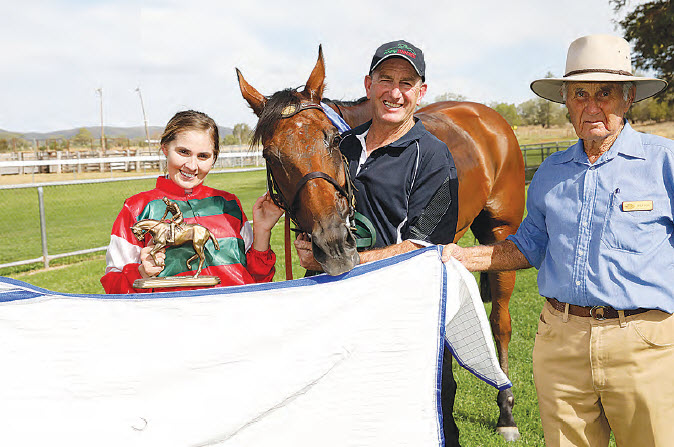 Jockey, Grace Willoughby, and trainer, Craig Martin, with the winner of the MGA Insurance Group Bingara Cup, Present Sense, with Bingara Jockey Club Patron, Doug Withers, who presented the trophy.