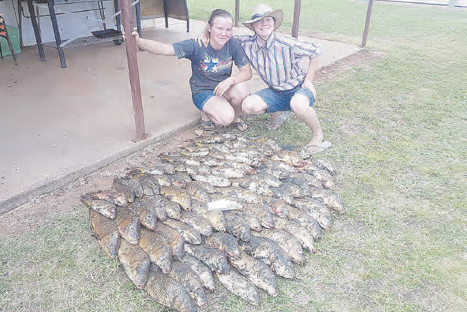 Sisters, Erin and Abbey Walker with 77 of the European carp Erin caught in the Horton River near their home.